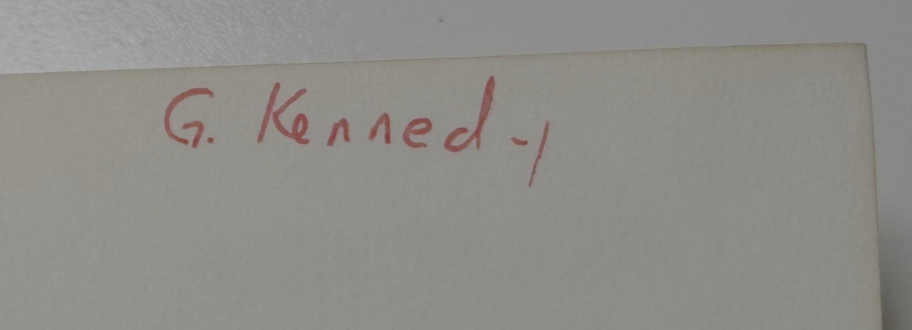 Manuscript signature reading G. Kennedy, in red ink, on the front free endpaper