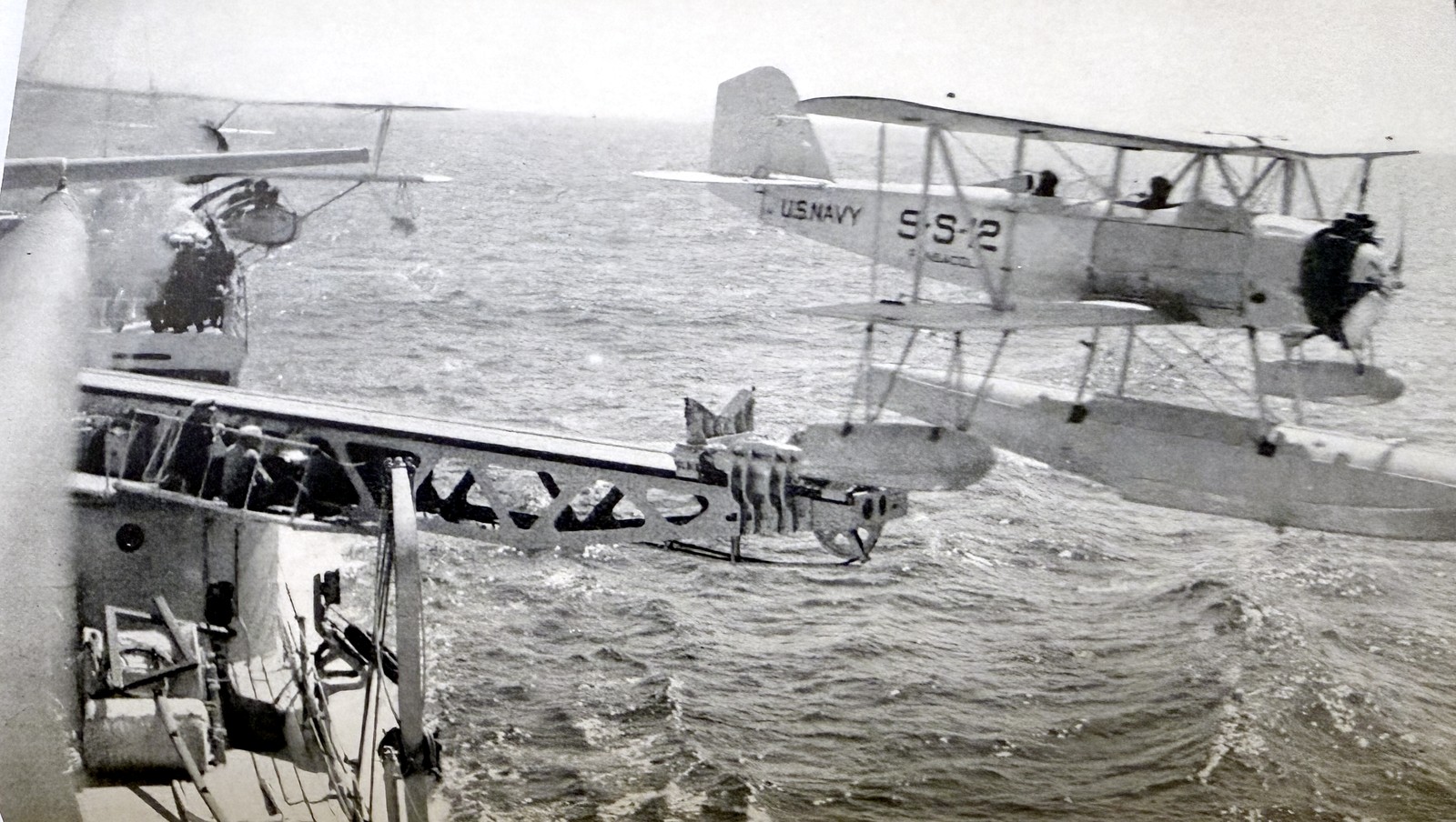U.S. Navy S-S-12 seaplane being hoisted alongside a catapult-equipped cruiser