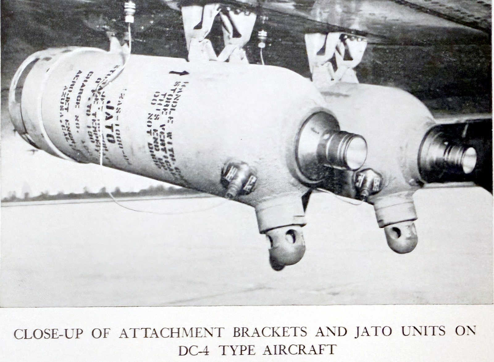 Close-up of JATO rocket units and attachment brackets mounted on a DC-4 wing