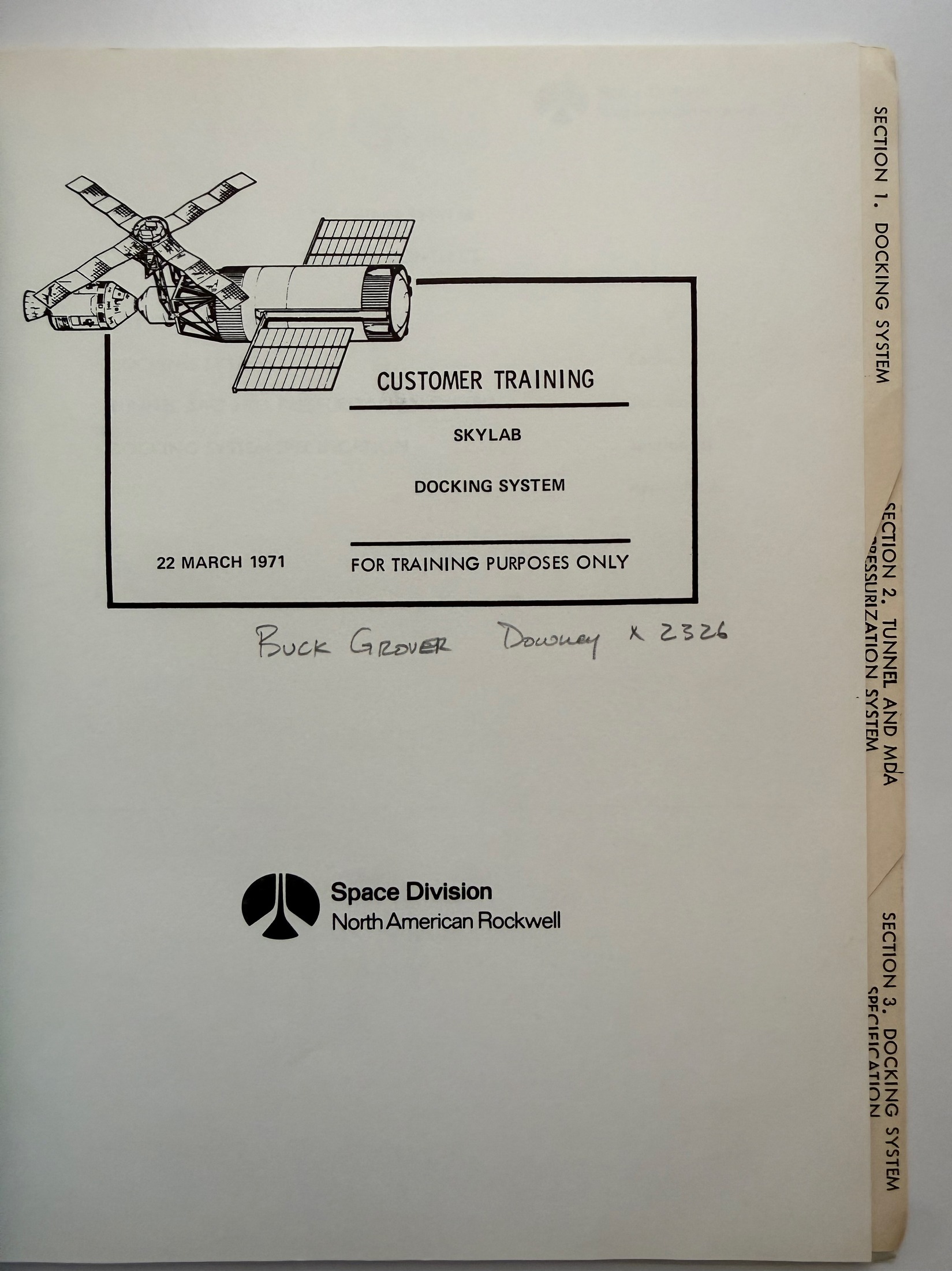 Interior title page of the Skylab Docking System customer training manual, with handwritten name Buck Grover, Downey, extension 2326